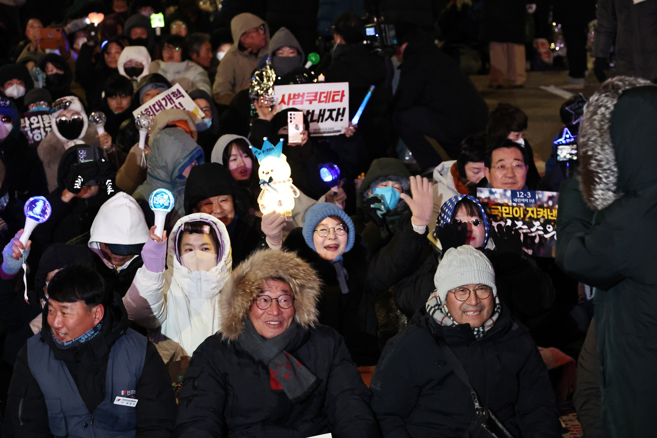 Demonstrators pack the streets in front of the National Assembly on Wednesday to mark the one-year anniversary of Yoon's martial law decree and impeachment, and to call for "just punishments" against Yoon and his aides. (Yonhap)