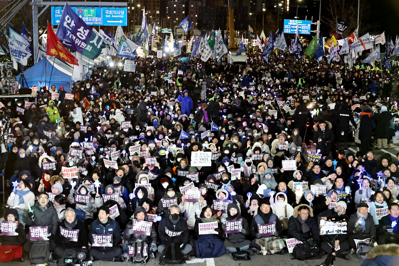 Demonstrators gather in front of the National Assembly on Wednesday to mark the one-year anniversary of former President Yoon Suk Yeol's martial law decree and impeachment. (Yonhap)